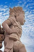 Image of a typical Balinese sculpture photographed against the blue sky photo