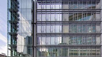 Glass front of high rise building in Frankfurt at daytime photo