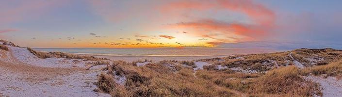 Panorama over the beach of the Danish coastal resort of Blavand at sunset photo