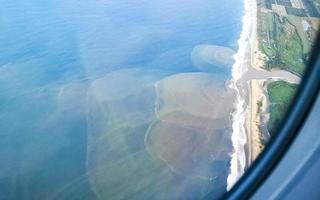 Flying in plane over coast of Oaxaca Mexico. photo