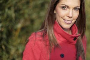 Pretty young woman in red coat photo