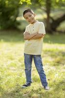 Little Korean boy standing in the park photo