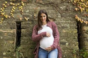 Young pregnant woman in the autumn park photo