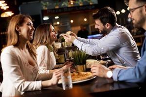 Young people having dinner in the restaurant photo