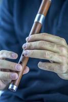 Wooden flute player photo