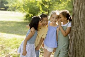 grupo de niños asiáticos y caucásicos divirtiéndose en el parque foto