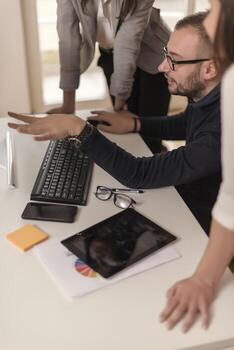Group of designers programmers working on a new project at the office. photo