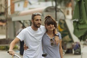 Couple of tourists having fun walking on city street at holiday - Happy friends laughing together on vacation - People and holidays concept photo