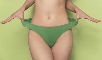 Woman with sportive slim body type in underwear photo