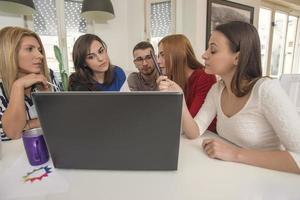 business woman explaining business matters to her team in a boardroom photo