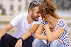 Couple of tourists having fun walking on city street at holiday - Happy friends laughing together on vacation - People and holidays concept photo