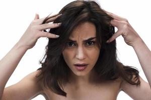 female woman holding her hair in her hand.  isolated on white background. photo