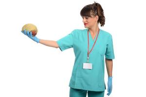 Female doctor holding a human brain model against white background photo