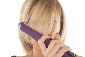 Closeup on young woman combing hair photo