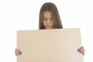 smiling girl holding blank sign board. studio portrait of young woman with sign card. isolated. photo