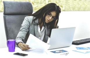 Business woman busy working on laptop computer at office. photo