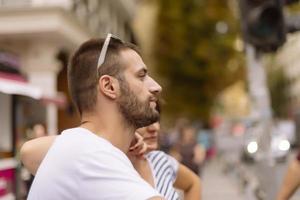 Couple of tourists having fun walking on city street at holiday - Happy friends laughing together on vacation - People and holidays concept photo