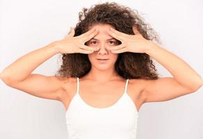 Photo of young girl amazed shocked afraid scared hands cover face eye look