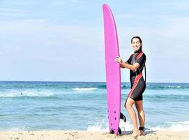 beautiful surfer girl on the beach photo