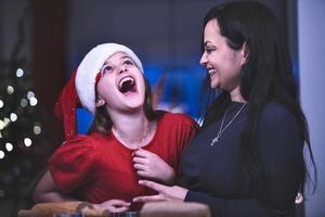 A happy Christmas concept. Mother and Daughter in a Christmas mood. photo