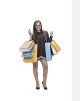 Happy woman full body portrait with shopping bag on isolated studio background. photo