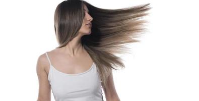 Portrait of the young woman with flying hair. isolated photo