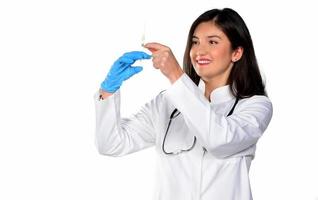 A young woman doctor with stethoscope preparing a injection, isolated on white background photo