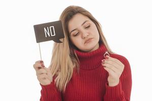 Woman holding engagement ring and sign saying YES photo