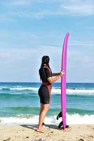 Beautiful sexy surfer girl on the beach photo