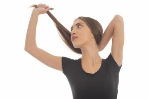 Young attractive smiling woman holding her strong hair photo