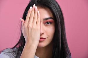 Photo of young attractive woman cover eye arm check-up vision ophthalmology isolated over pink color background