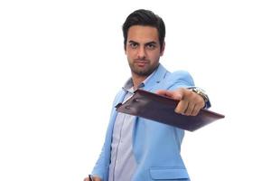 Arab businessman holding paperwork on clipboard and pointing with his finger. isolated on white photo