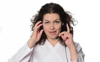 Gorgeous brunette lady listening music in headphones photo