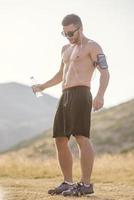 Athletic young man stretching after run in the nature. sport concept photo