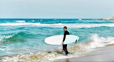 surfer man on the beach photo