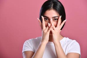 Photo of young asian girl amazed shocked afraid scared hands cover face eye look