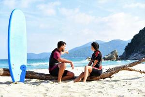 friends relaxing and talking on the beach photo