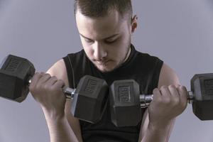 male holding  dumbbells photo