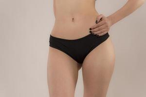 Woman with sportive slim body type in underwear photo