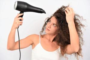 Beautiful girl drying her hair photo