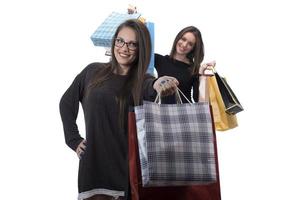 Happy friends with shopping bag on isolated studio background. photo