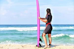 beautiful surfer girl on the beach photo