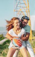 Couple playing American football on hot summer day. Couple playing Rugby photo shoot