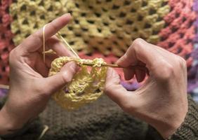 unrecognizable woman knitting photo