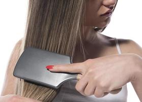 Young beautiful woman with long hair combing her hair in the morning. Hair care concept. photo