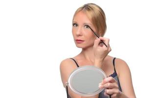 Image of joyful woman smiling at camera and using makeup brush photo