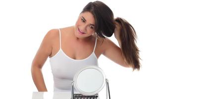 female woman holding her hair in her hand.  isolated on white background. photo