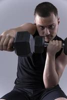 male holding  dumbbells photo