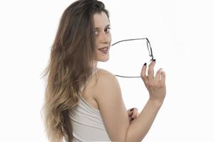 beautiful young woman holding eye glasses photo