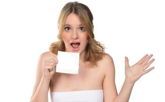 Portrait of young beautiful woman peeping at the camera holding white blank sign photo